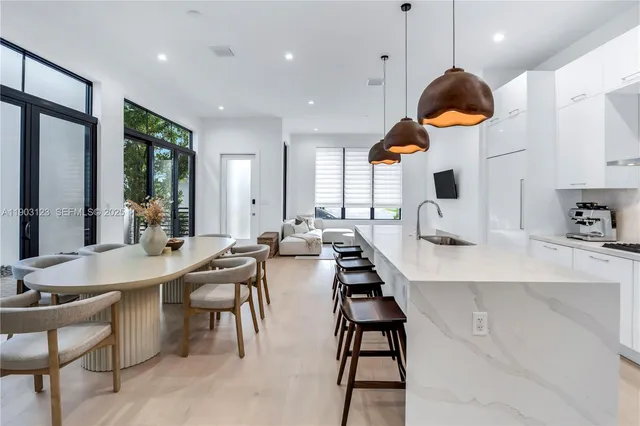 a large kitchen with a table and chairs