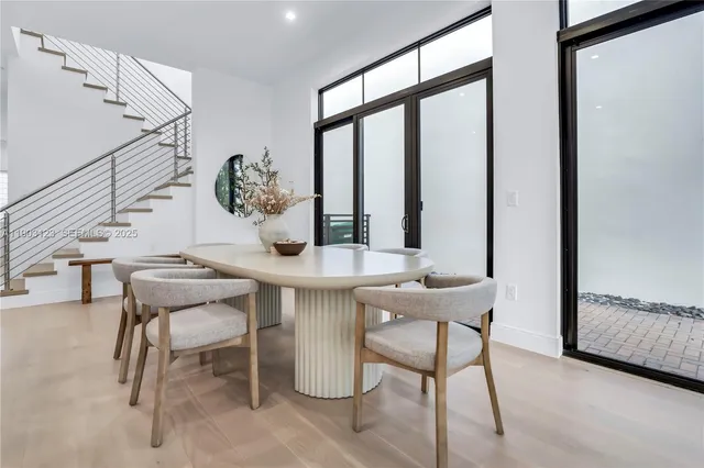 a view of a dining room with furniture and a window