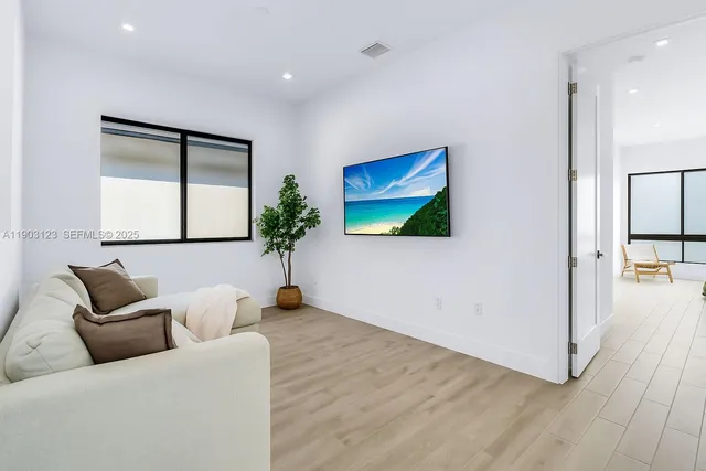 a living room with furniture and a flat screen tv