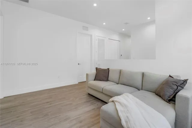 a living room with a couch and a ceiling fan