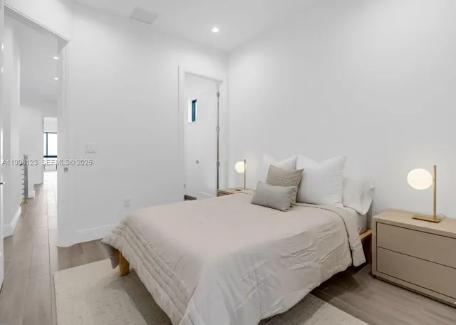 a bedroom with a bed and a lamp