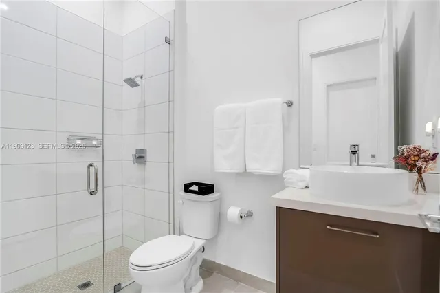a bathroom with a sink toilet and shower