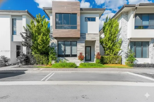 a front view of a house with a garden