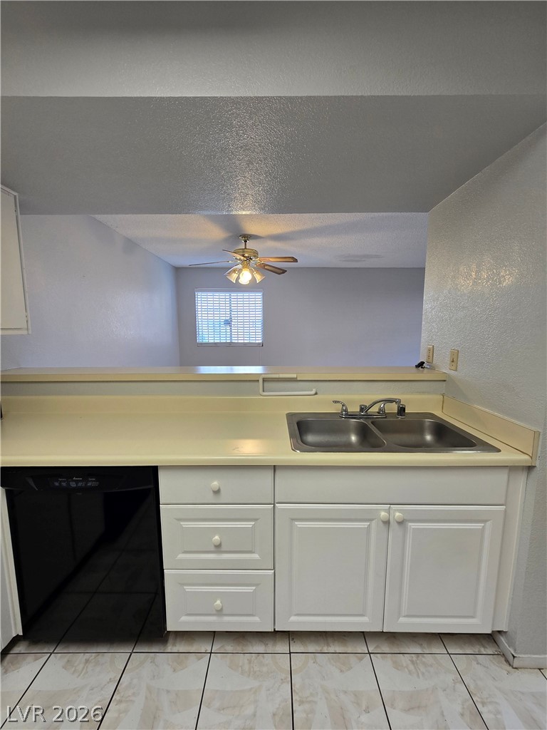 6750 Del Rey Avenue, Unit 133 Las Vegas, NV 89146 - Photo 13 of 34 A well-appointed kitchen features a double-basin sink and a convenient pass-through window to the adjacent living space.