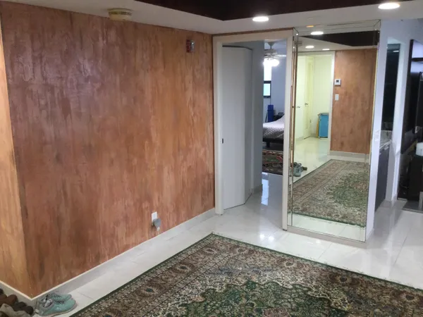 a living room with furniture and a floor to ceiling window
