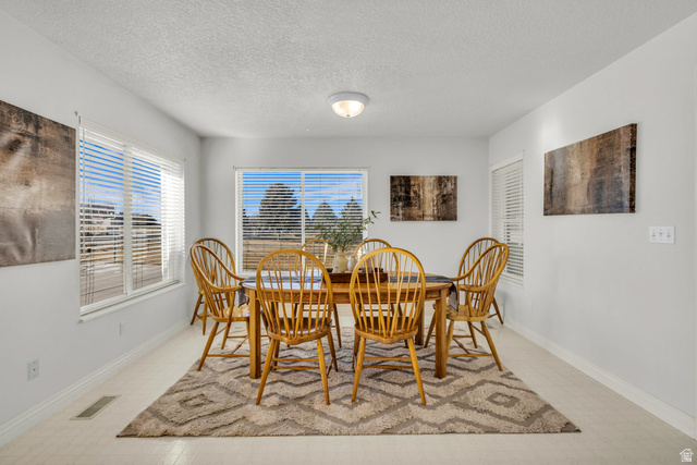 1060 West 2620th Street South Mapleton, UT 84664 - Photo 17 of 87 Dining room featuring a textured ceiling and baseboards