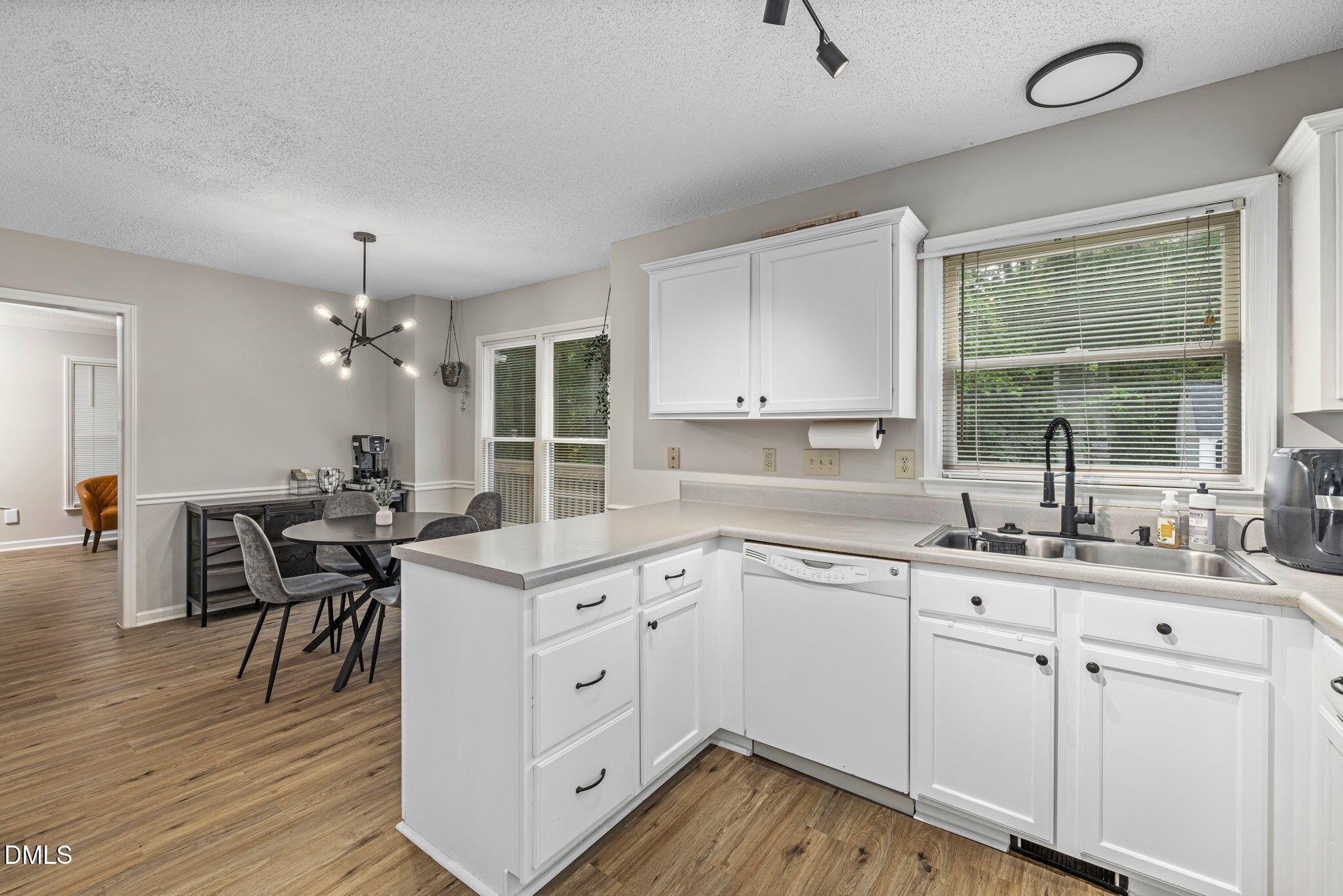 403 Chadbourne Drive Durham, NC 27703 - Photo 13 of 30 a kitchen with a sink window and cabinets