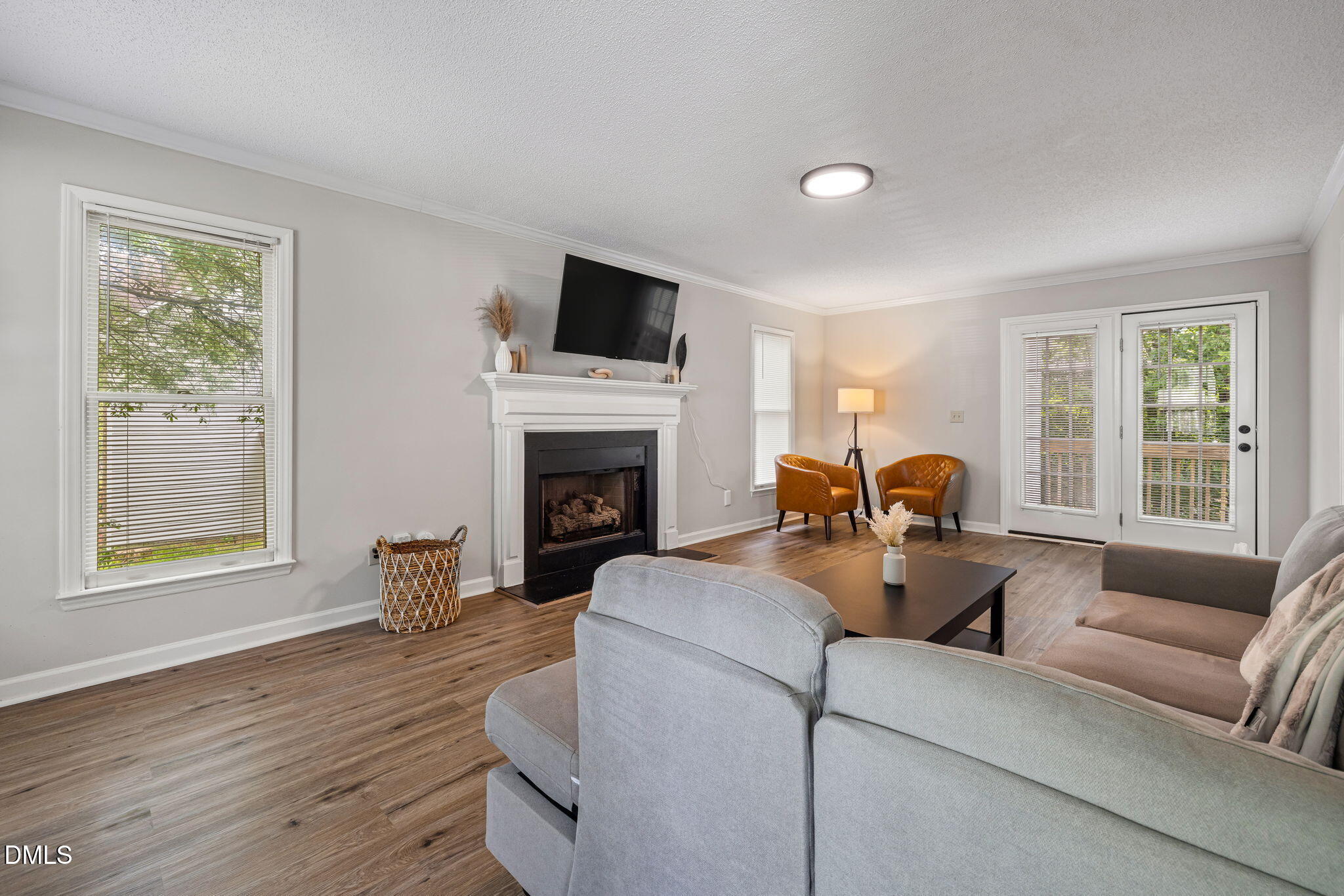 403 Chadbourne Drive Durham, NC 27703 - Photo 8 of 30 a living room with furniture a fireplace and a flat screen tv
