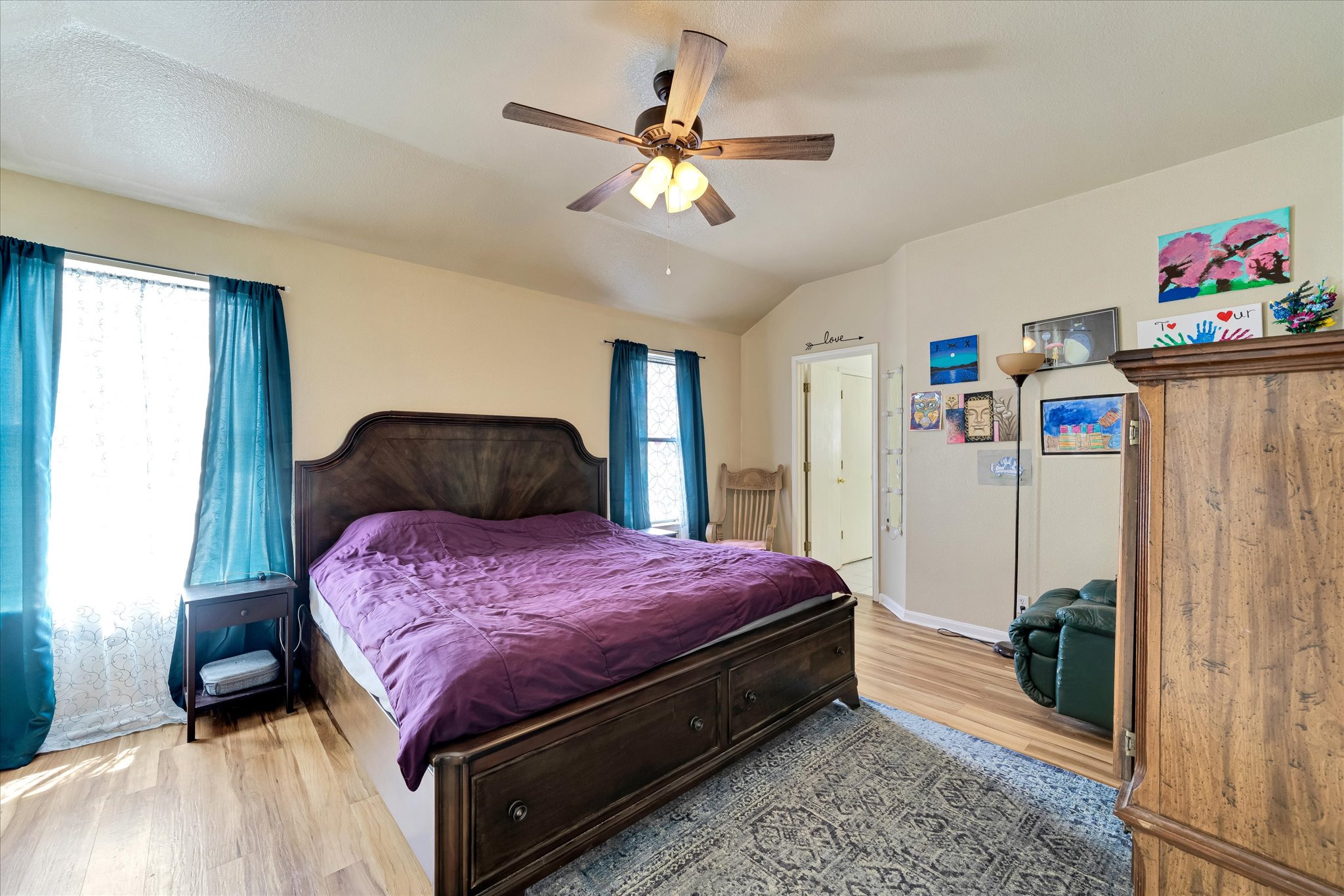 2601 Highcloud Drive Lockhart, TX 78644 - Photo 18 of 30 a bedroom with a bed and a chandelier