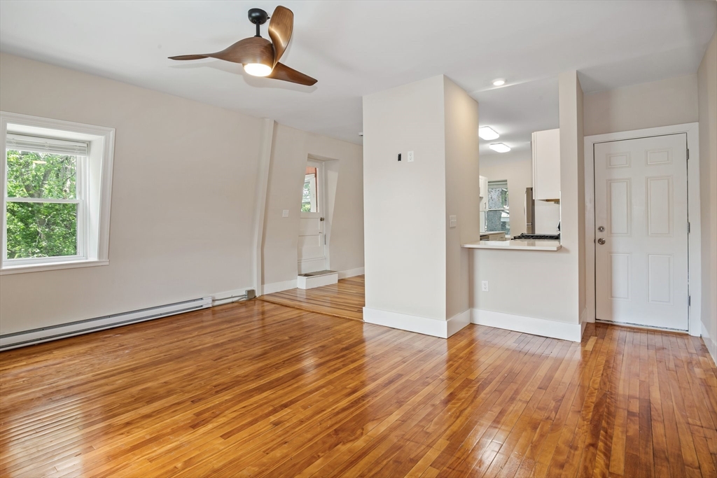 35 Oak Avenue, Unit 3 Worcester, MA 01605 - Photo 13 of 24 a view of a kitchen with wooden floor and a ceiling fan