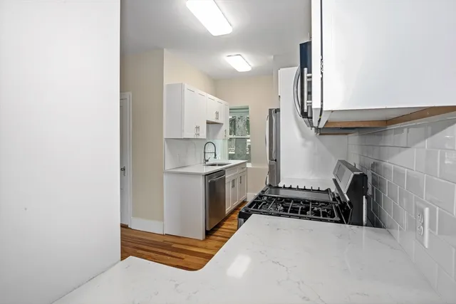 a kitchen with a sink and a stove top oven
