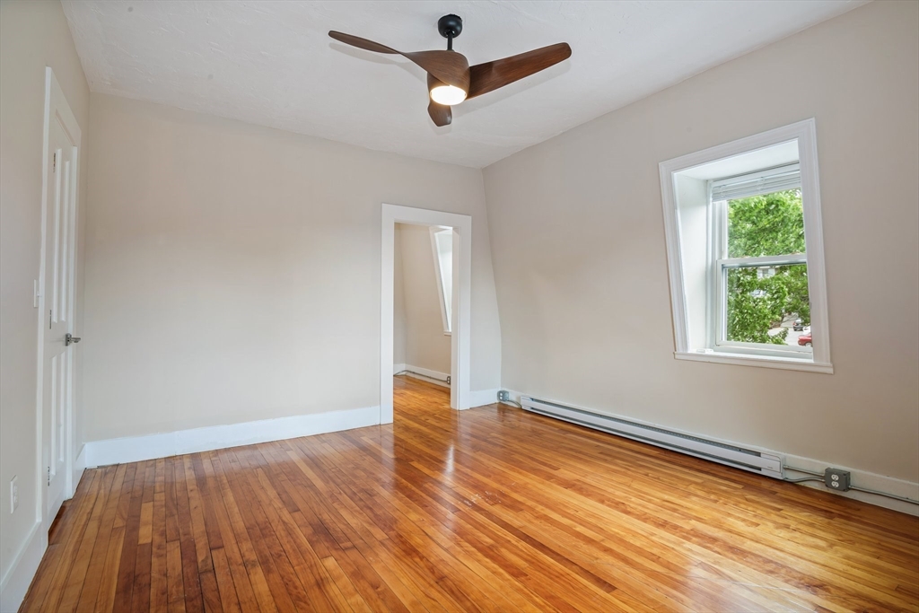 35 Oak Avenue, Unit 3 Worcester, MA 01605 - Photo 8 of 24 an empty room with wooden floor ceiling fan and windows