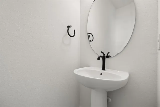 a bathroom with a sink and mirror