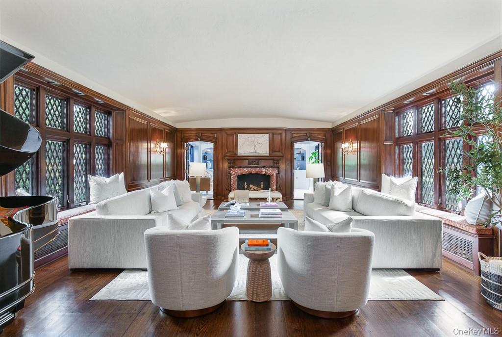 21 Hampshire Road Bronxville, NY 10708 - Photo 5 of 41 The majestic formal living room is detailed with a barreled ceiling, restored Cuban mahogany wood panelling, an and original wood-burning fireplace with a rare Rosso Levanto marble surround and herringbone limestone interior. Two sets of french doors open to a sun-filled office/study.