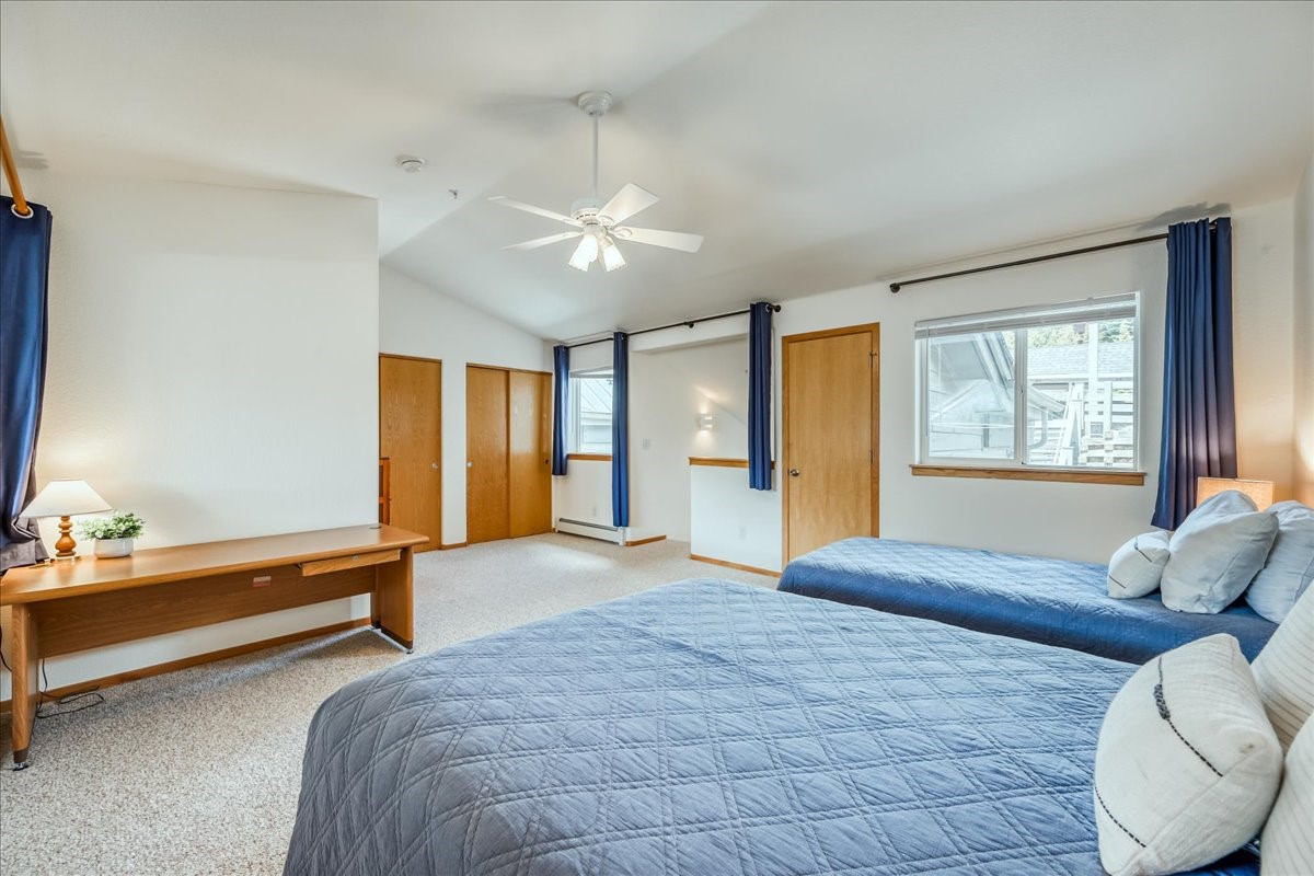 91399 Ryan Gulch Road, Unit B6 Silverthorne, CO 80498 - Photo 23 of 36 a spacious bedroom with a large bed and a window