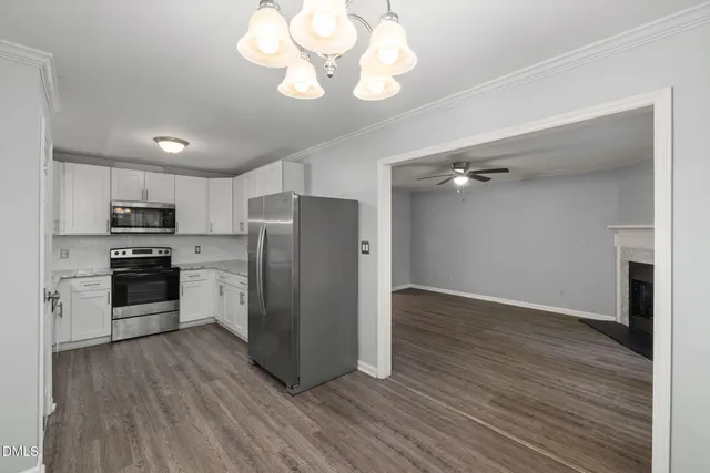 a kitchen with stainless steel appliances granite countertop a refrigerator and a sink