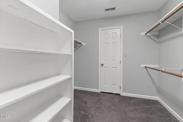 a view of an empty room with a ceiling fan