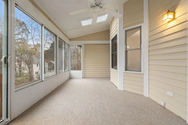 a view of an empty room with glass door