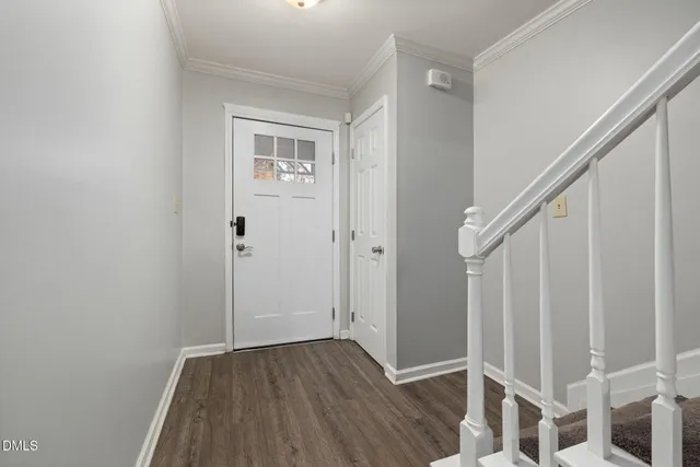 a red car parked in front of white house