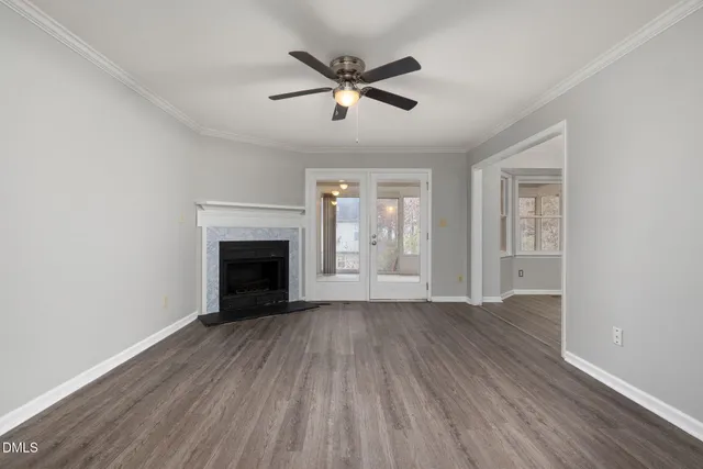 a view of a hallway with wooden floor and entryway