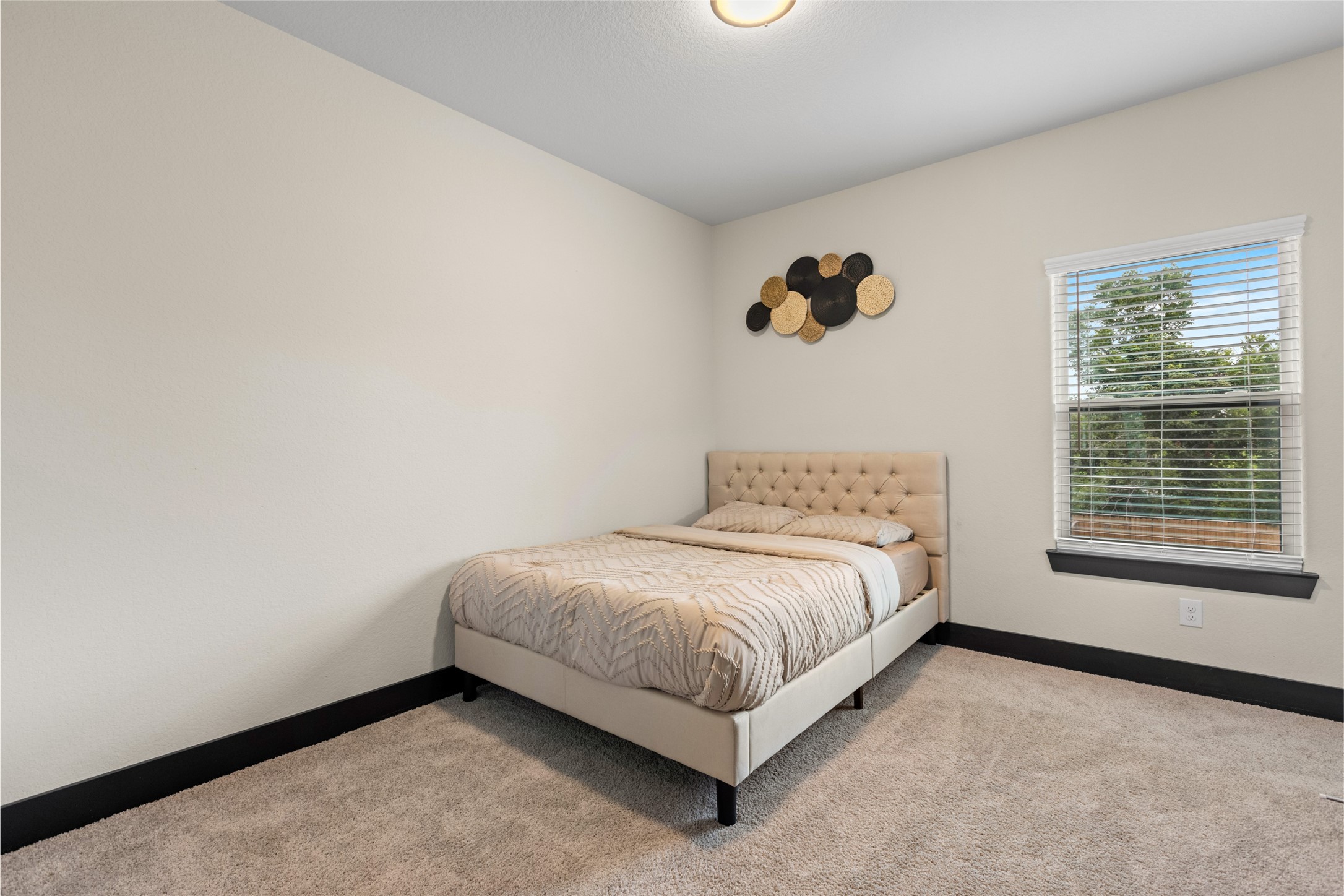 4435 Maggie Street, Unit B Houston, TX 77051 - Photo 27 of 37 a spacious bedroom with a bed and a window