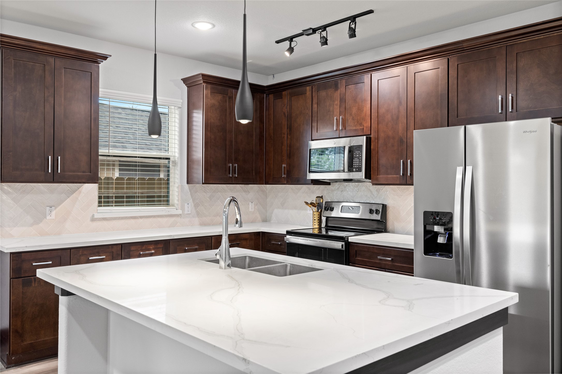 4435 Maggie Street, Unit B Houston, TX 77051 - Photo 5 of 37 a kitchen with stainless steel appliances a sink a stove a refrigerator cabinets and wooden floor