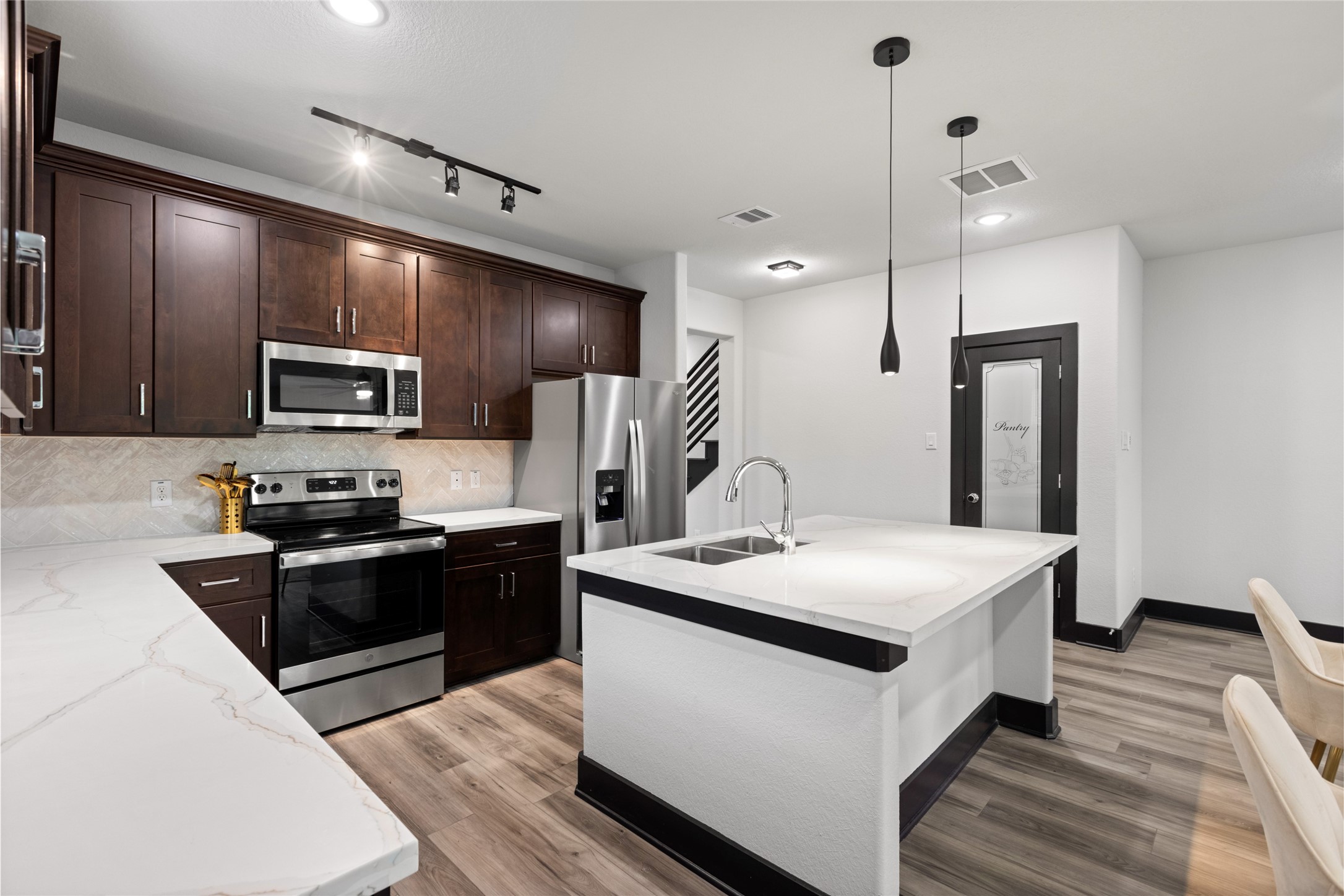 4435 Maggie Street, Unit B Houston, TX 77051 - Photo 6 of 37 a kitchen with a sink stainless steel appliances and wooden floor