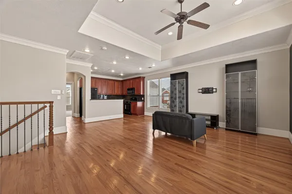 a living room with furniture and a wooden floor