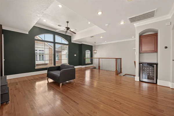 a living room with fireplace furniture and a wooden floor