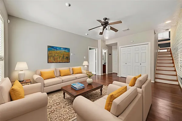 a living room with furniture and wooden floor