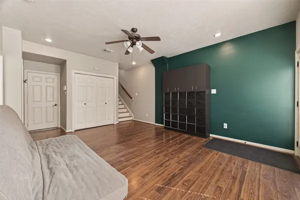 a view of a livingroom with a ceiling fan and window
