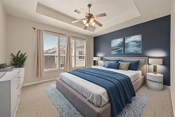 a spacious bedroom with a large bed and a chandelier