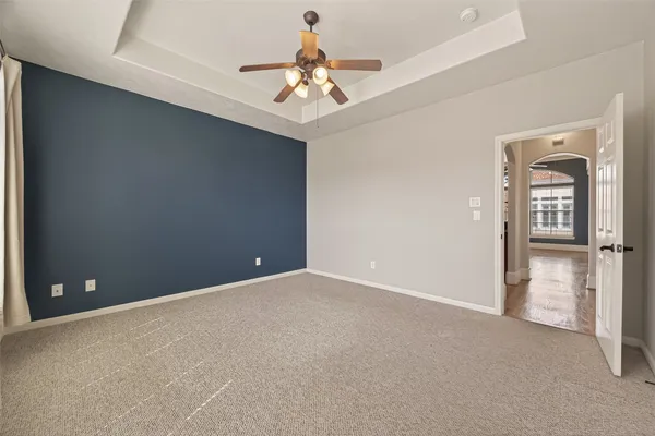 an empty room and chandelier fan