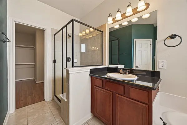 a bathroom with a sink vanity and a mirror
