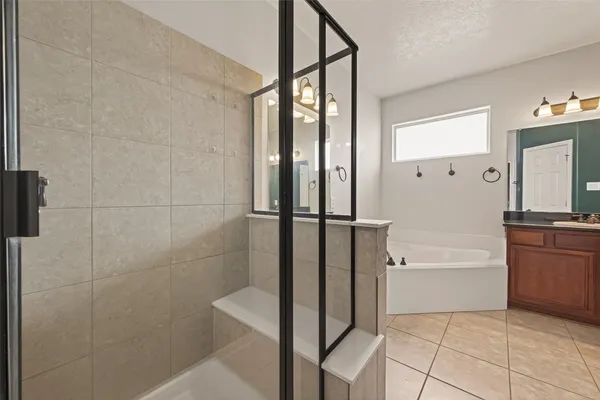 a bathroom with a bathtub and a shower