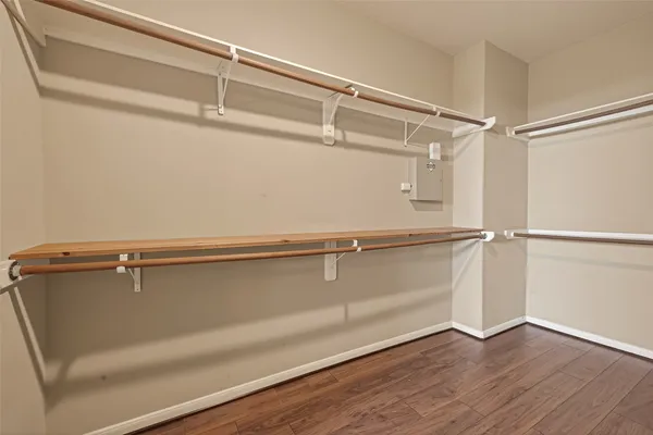 a view of a room with wooden floor