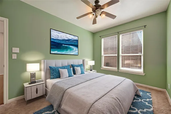 a bedroom with a large bed and a window
