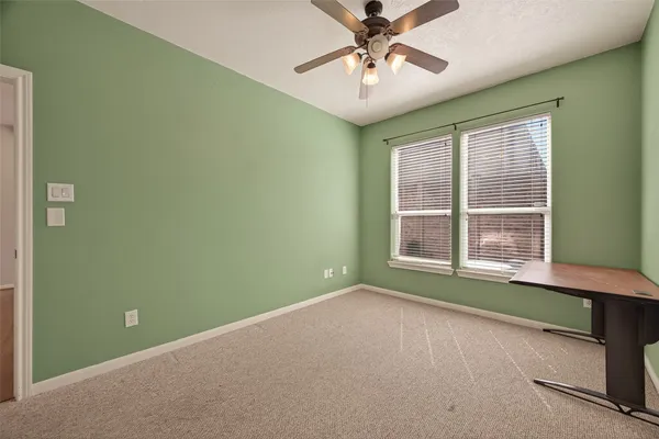 a view of room with a ceiling fan and a window