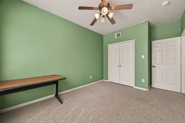 a view of room with a ceiling fan and a hardwood