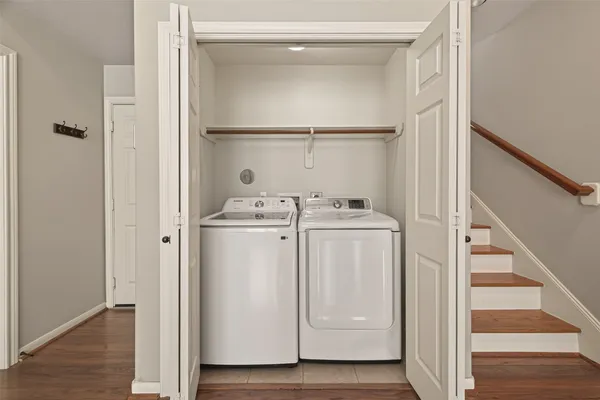 a utility room with cabinets washer and dryer