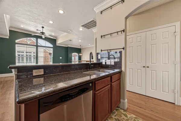 a kitchen with granite countertop a sink and a stove