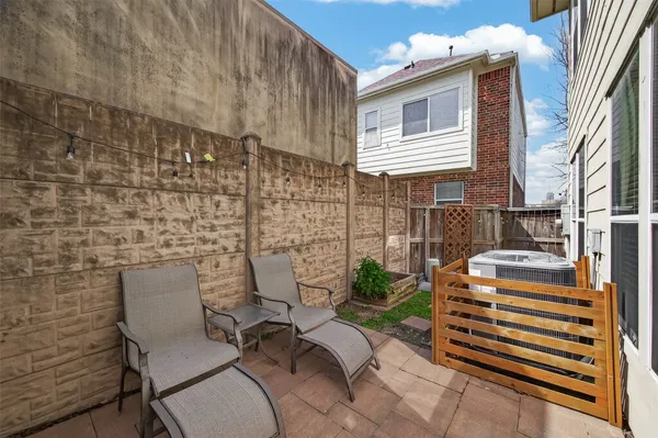 a balcony with table and chairs