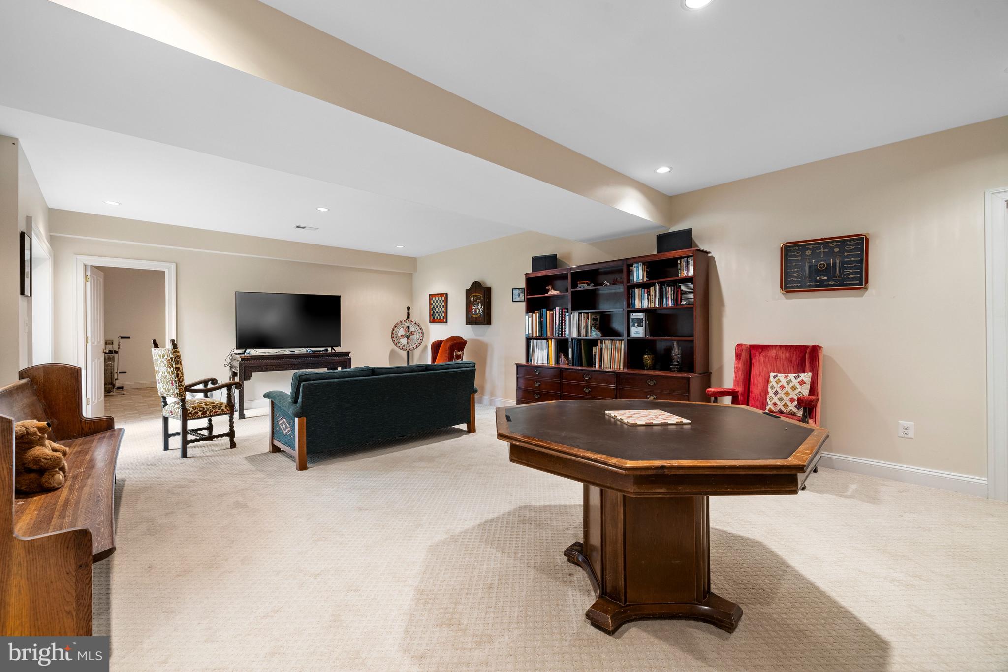 20147 Woodtrail Road Round Hill, VA 20141 - Photo 35 of 41 a living room with furniture and a flat screen tv