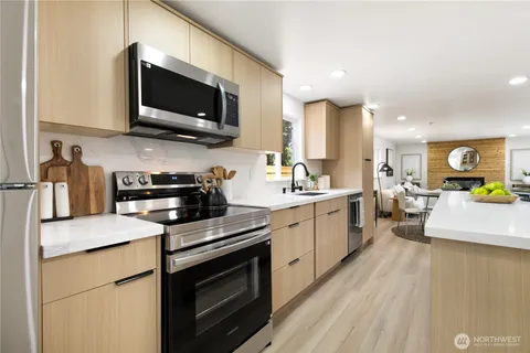 a kitchen with a sink stainless steel appliances and cabinets
