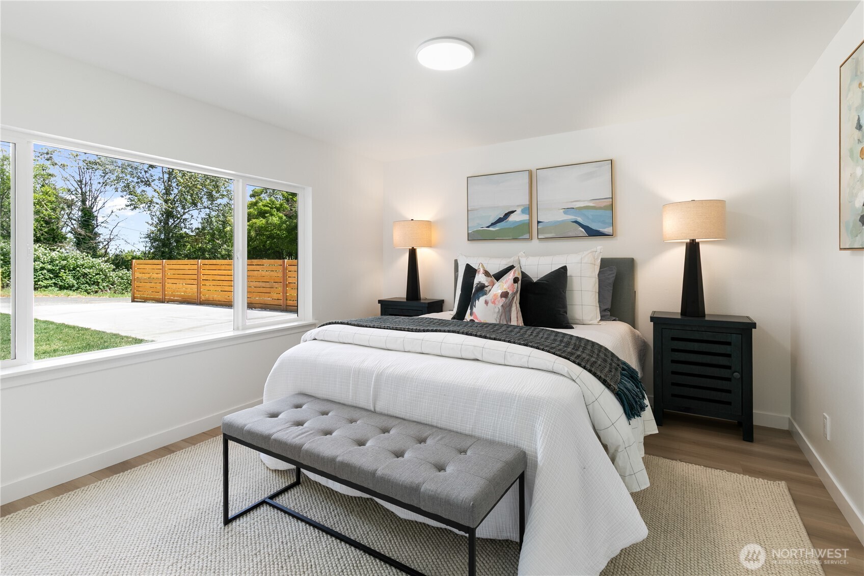 11 Southwest 100th Street Seattle, WA 98146 - Photo 17 of 36 a bedroom with a bed and a lamp on table