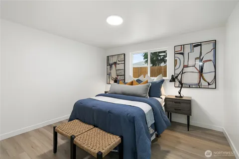 a bed room with a bed window and a chair