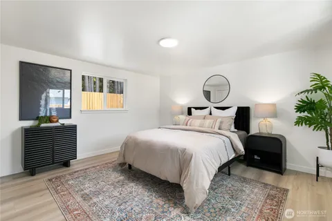 a bedroom with a bed and a potted plant