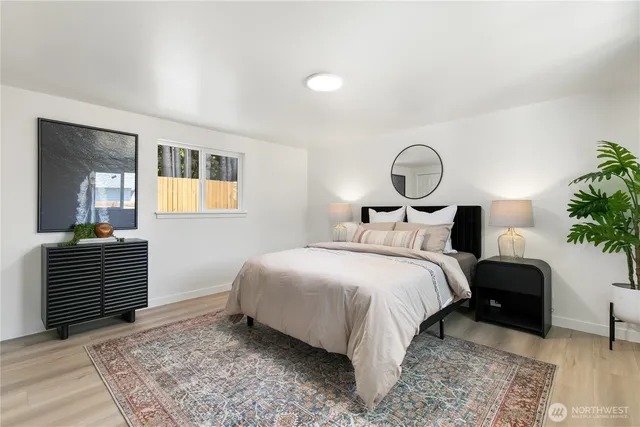 a bedroom with a bed and a potted plant