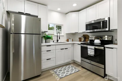 a kitchen with a refrigerator stove and microwave