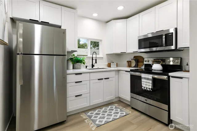 a kitchen with a refrigerator stove and microwave